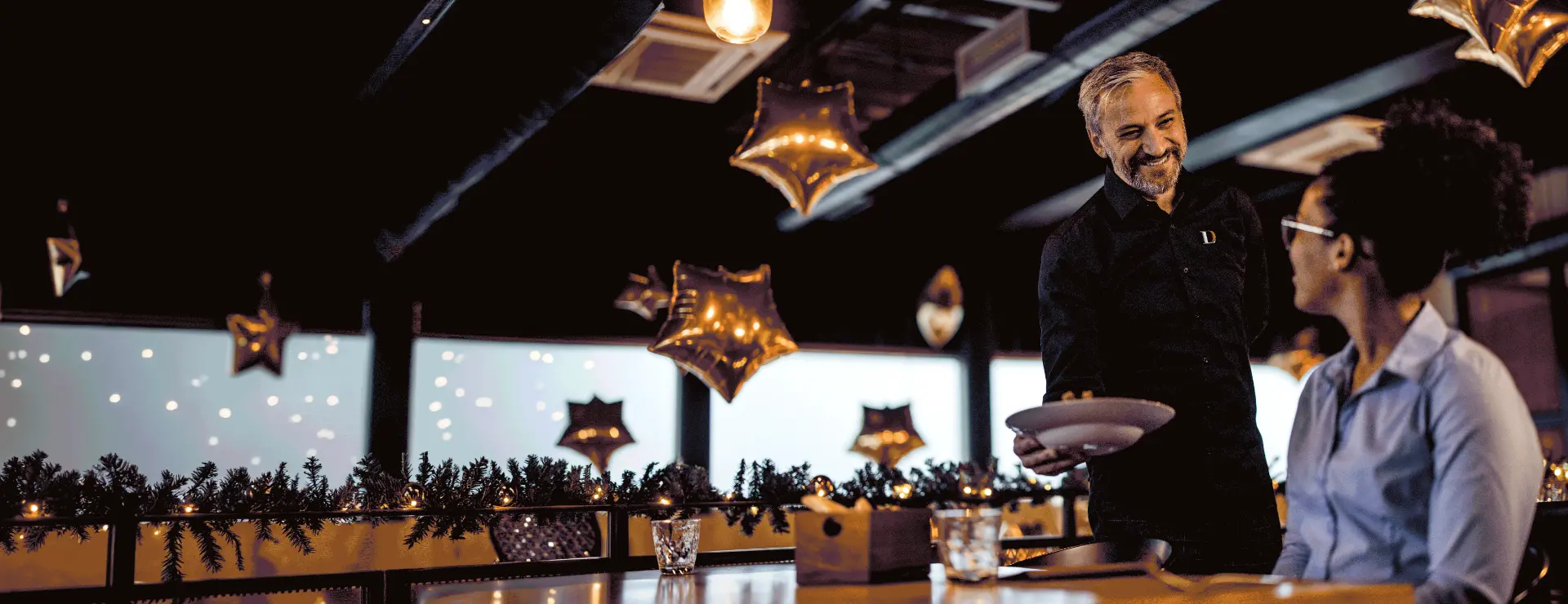 DL hospitality professional serving a guest